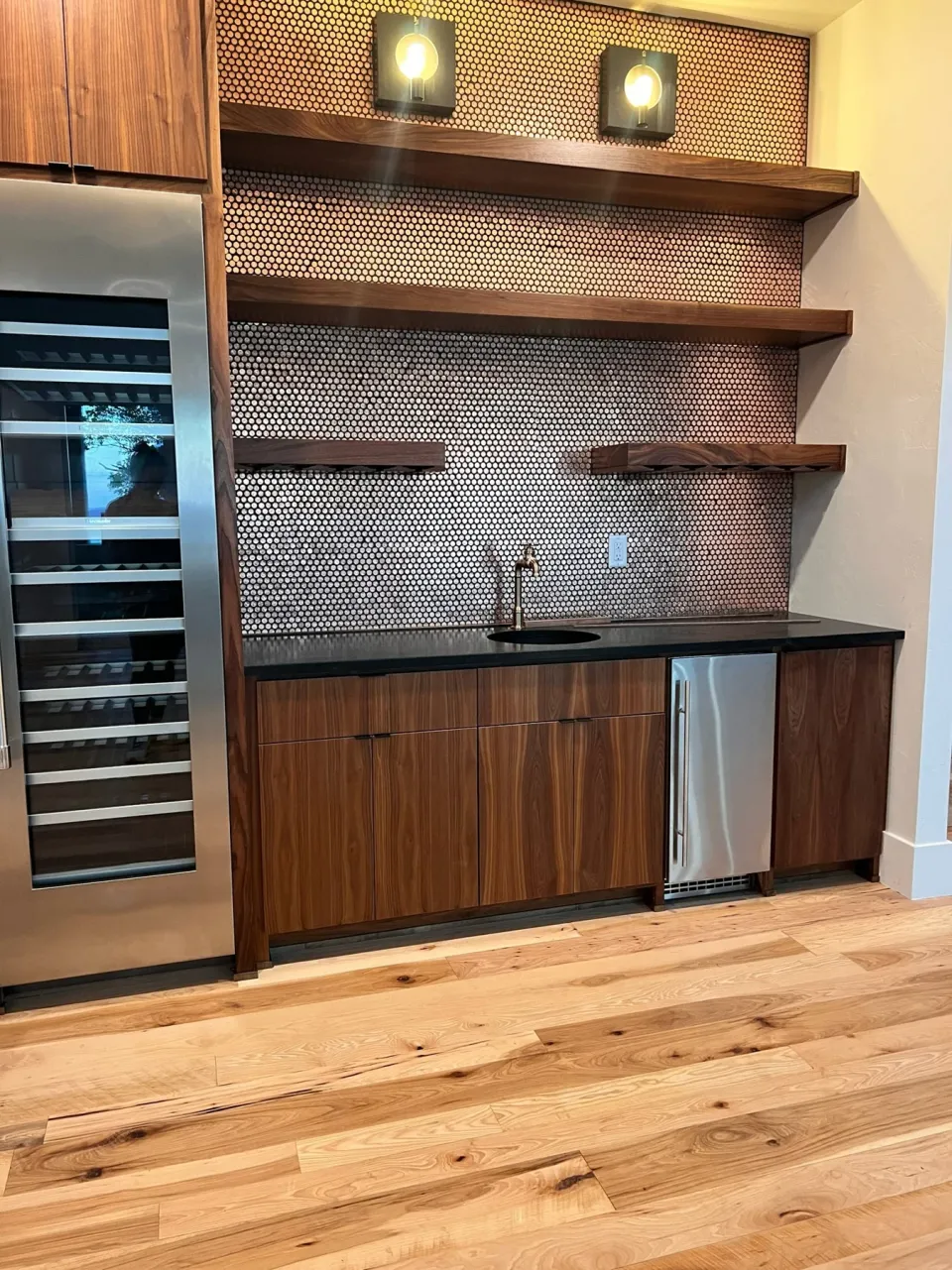 Wood cabinetry and open shelving with a penny backsplash